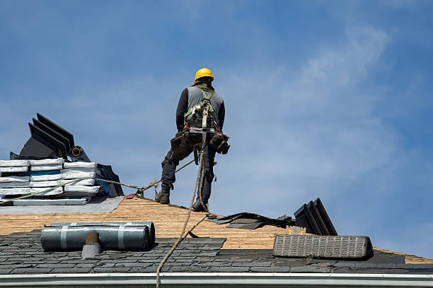 Professional Gutter Installation technician working in Howells, NE